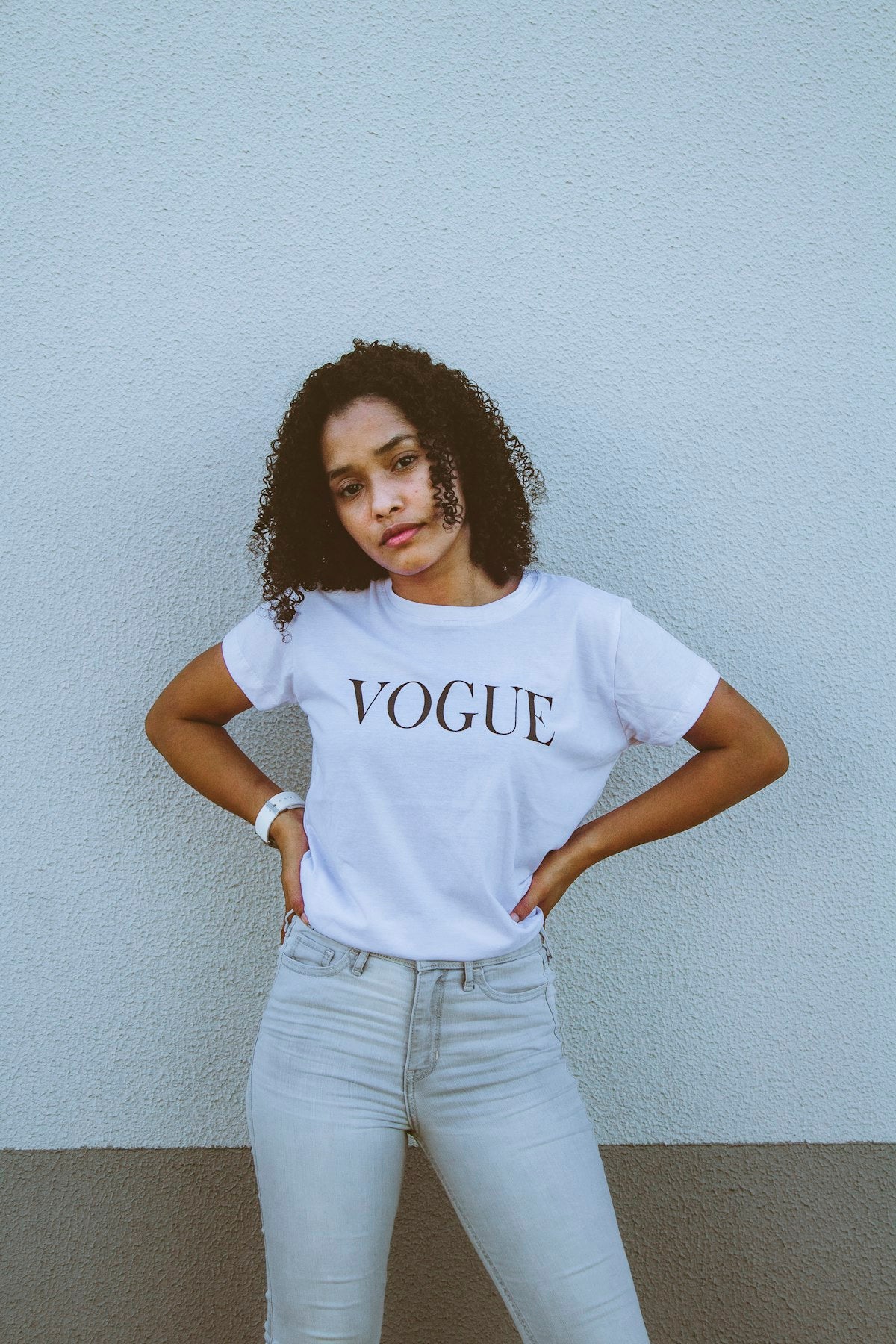 Woman in a white t-shirt and denim jeans