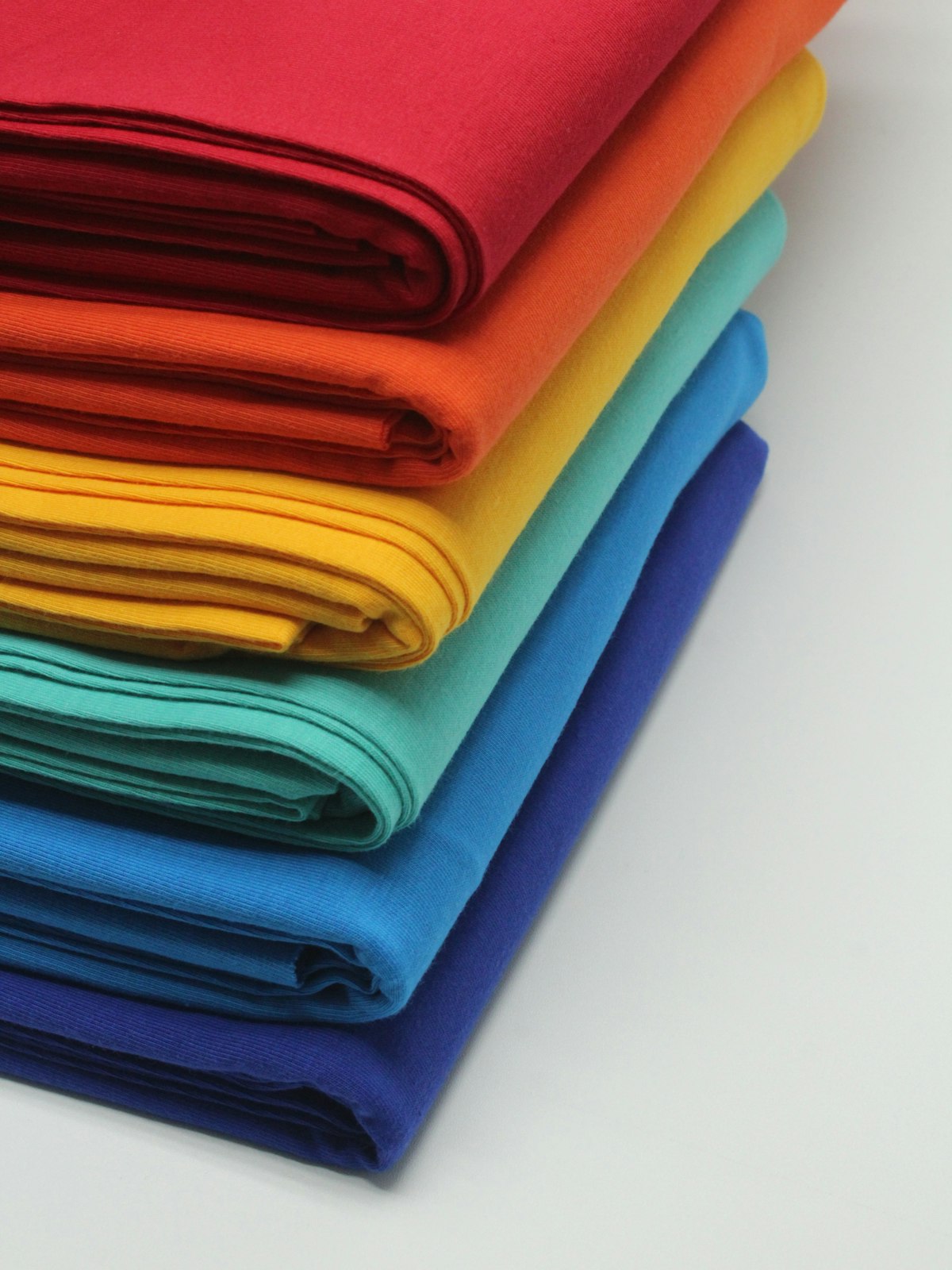 Stack of bright colored folded fabrics