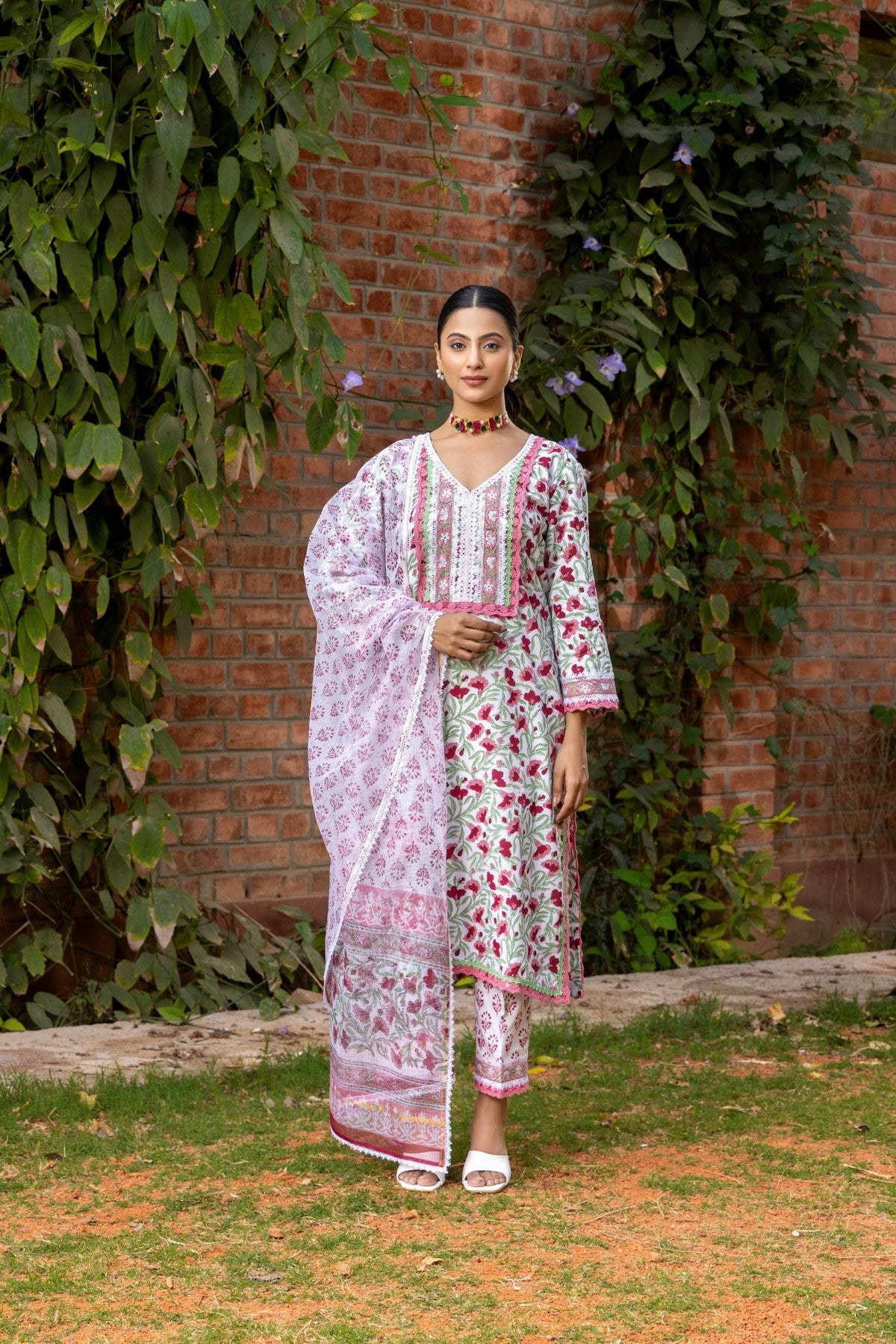 Woman modeling a floral indian suit with a dupatta