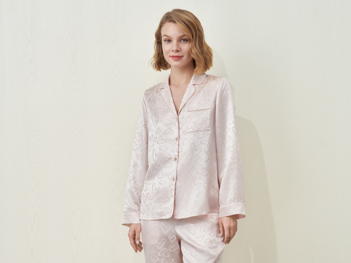 Woman wearing a light pink patterned pajama set
