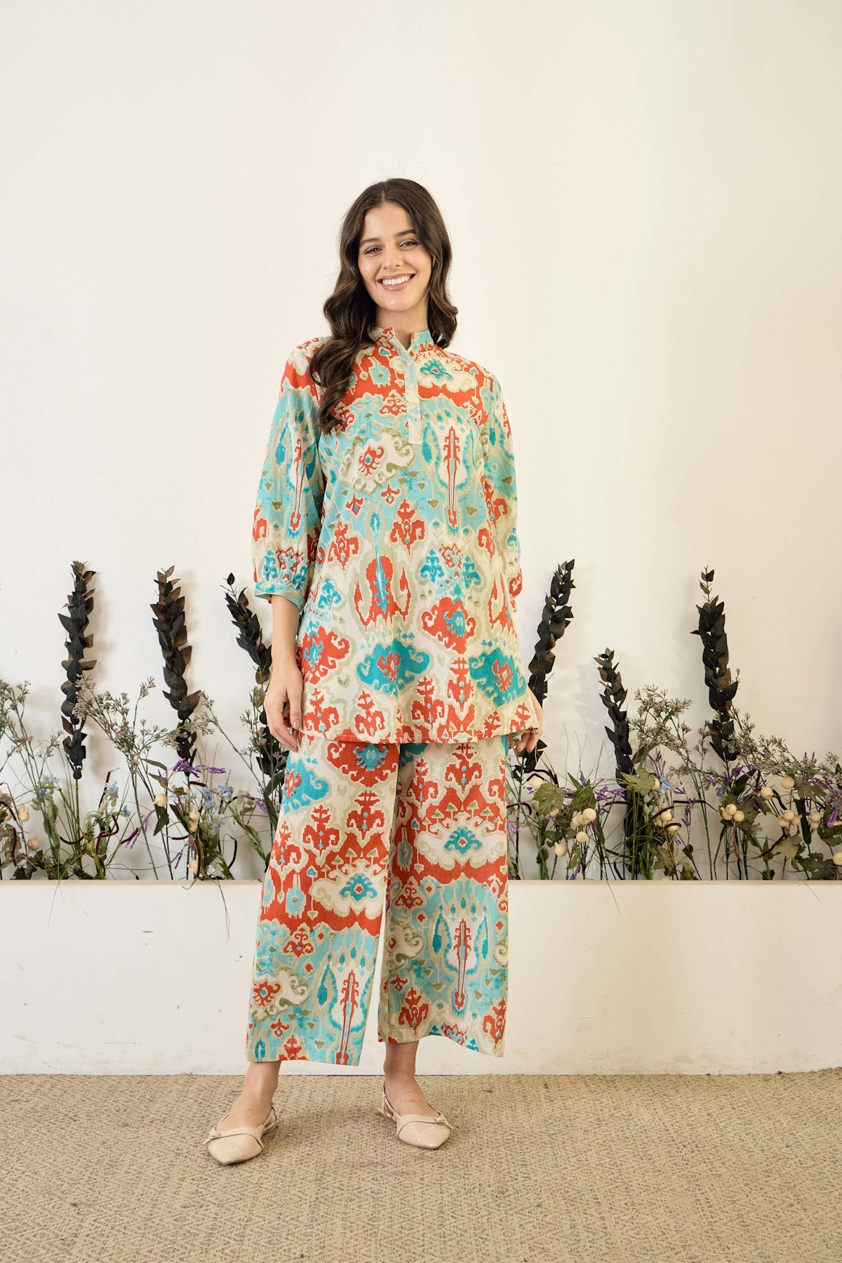 Woman in patterned tunic and wide-leg pants